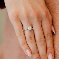 Hand mit Lab Diamant im Emerald Schliff am Ringfinger in Weißgold