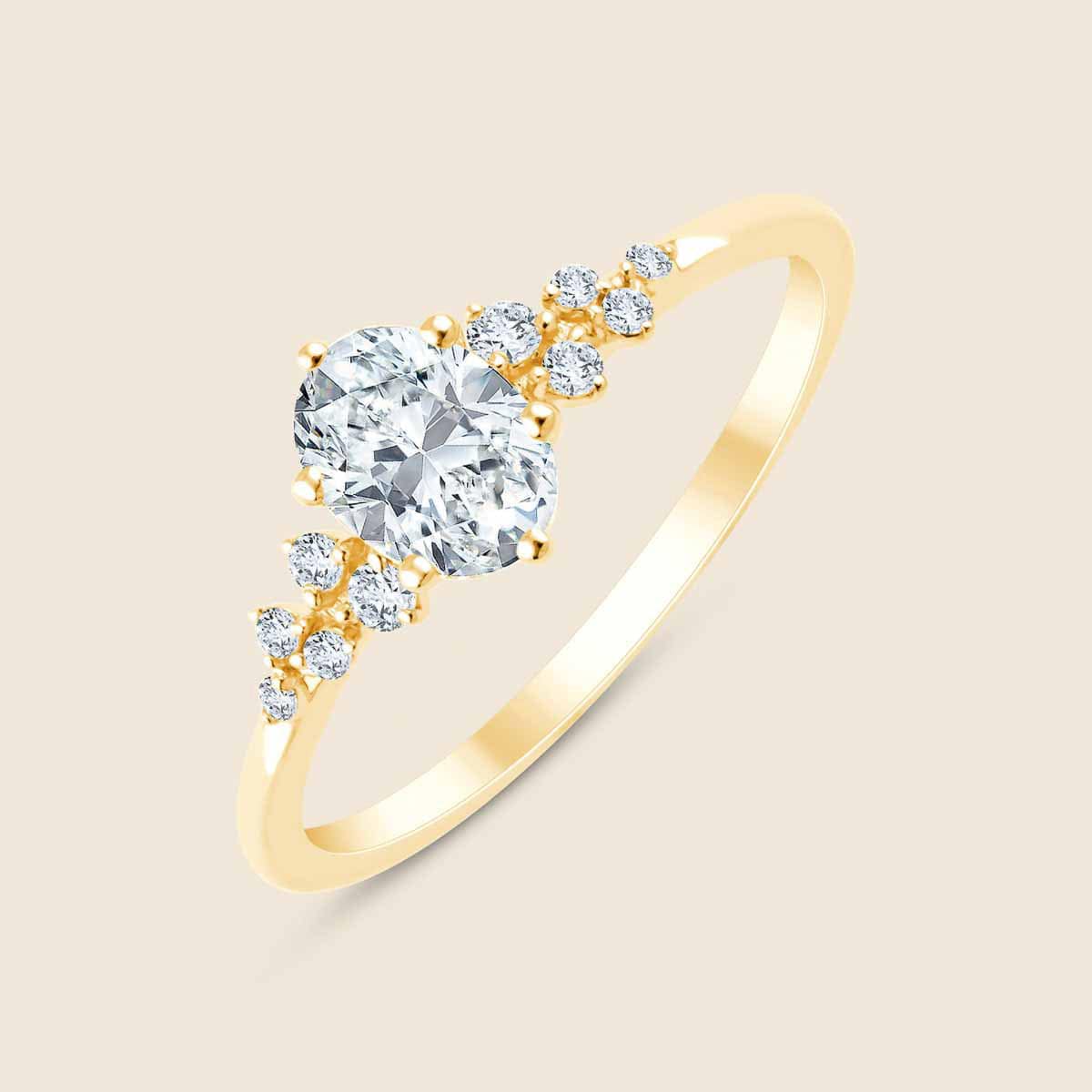 Goldring mit kleineren  und mittig zentralem Lab Diamanten in Ovalschliff