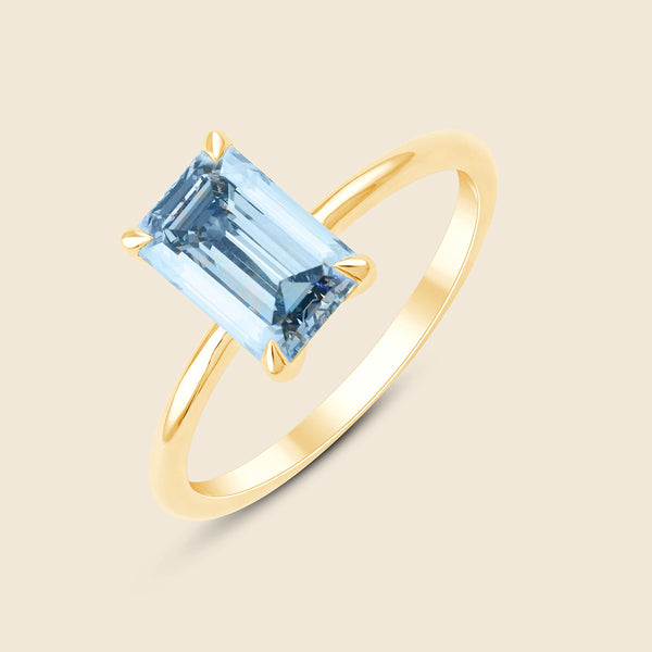 Goldener Ring mit blauem Lab-Diamant im Smaragd-Schliff