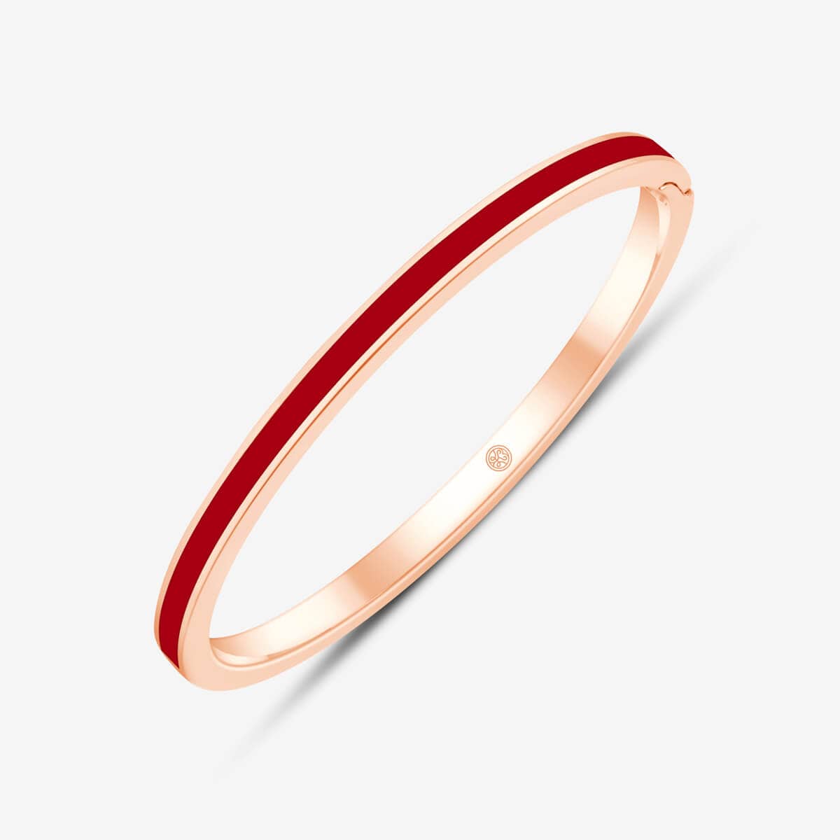 Rotes Keramik in rosegoldenen Armreif eingearbeitet